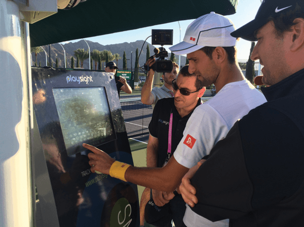 Novak Djokovic engaging with PlaySight kiosk