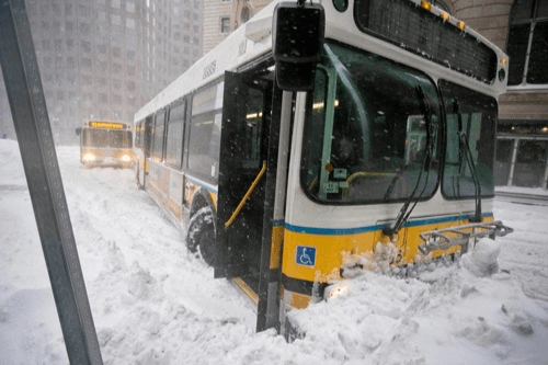 An MBTA bus struggles through the snow Source: Boston Globe