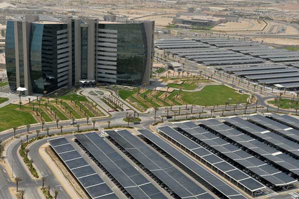 An Aramco office building in Saudi Arabia integrates solar panels in the shaded parking lot