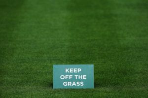 LONDON, ENGLAND - JUNE 22: A General View of a 'keep of the grass' sign seen on a one of the courts during previews for Wimbledon Championships at Wimbledon on June 22, 2014 in London, England. (Photo by Steve Bardens/Getty Images)