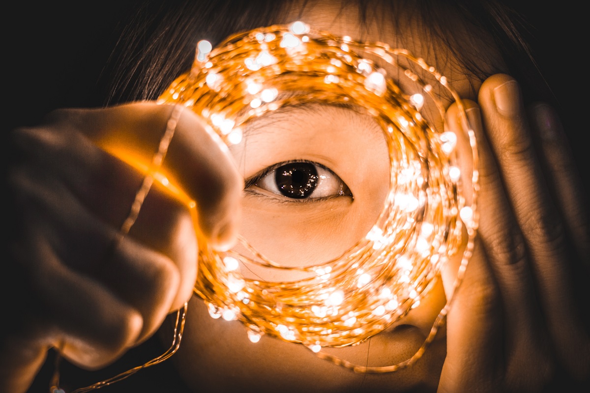 Woman's eye looking through ring of lights