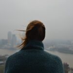 woman overlooking a city in smog