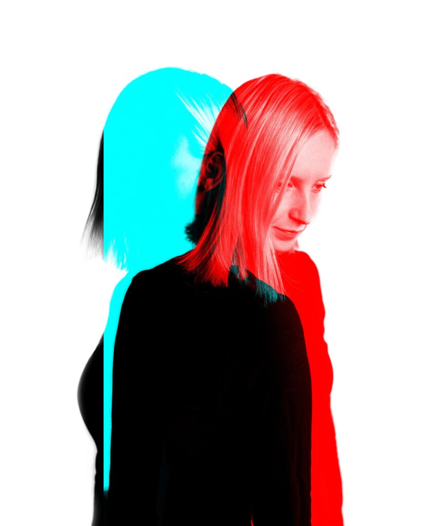 A double exposure image of a woman in red and blue